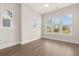Bright, empty bedroom with hardwood floors and large windows providing ample natural light at 113 Jackson Pond Ct, Summerville, SC 29486