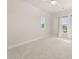 Bright bedroom with neutral paint and carpet features two windows with blinds and curtains at 113 Jackson Pond Ct, Summerville, SC 29486
