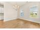 Bright dining room showcasing wood floors and large windows with charming views at 113 Jackson Pond Ct, Summerville, SC 29486