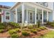 Inviting front porch with a seating area and beautifully landscaped surroundings at 113 Jackson Pond Ct, Summerville, SC 29486