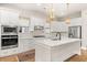 Elegant kitchen featuring a spacious island, built-in appliances, and designer light fixtures at 113 Jackson Pond Ct, Summerville, SC 29486