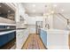 Bright kitchen features white cabinets, stainless steel appliances, quartz counters, an island, and stylish gold pendant lights at 113 Jackson Pond Ct, Summerville, SC 29486