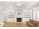 Bright living room featuring a fireplace, built-in shelves, and French doors at 113 Jackson Pond Ct, Summerville, SC 29486