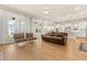 Open-concept living area with wood floors, a leather sofa, and French doors to the outside at 113 Jackson Pond Ct, Summerville, SC 29486