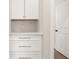 Built-in storage cabinets with quartz countertops and drawers, next to a doorway at 113 Jackson Pond Ct, Summerville, SC 29486