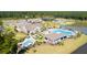 Aerial view of a residential community featuring a pool, lake, clubhouse, and amenities surrounded by lush landscaping and trees at 114 Magnolia House Dr, Summerville, SC 29486