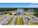 Aerial shot of parking, tennis courts, clubhouse, walking path, and lake featuring manicured lawns and tree lined streets at 114 Magnolia House Dr, Summerville, SC 29486