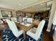 Bright dining area with a wooden table, upholstered chairs, and nautical decor, open to the kitchen at 114 Magnolia House Dr, Summerville, SC 29486