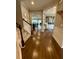 Hallway with hardwood floors, staircase, and views of the open kitchen and living areas at 114 Magnolia House Dr, Summerville, SC 29486