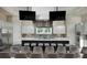 Bright, open kitchen features a large island, stainless steel appliances, and overhead television screens at 114 Magnolia House Dr, Summerville, SC 29486