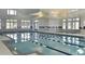 Bright indoor pool with spa, large windows, tiled walls, and signs reminding of pool rules at 114 Magnolia House Dr, Summerville, SC 29486