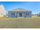 Home featuring a backyard with pergola over concrete patio and blue siding at 124 Pontoria Dr, Knightsville, SC 29483