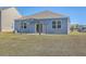 Backyard features grass, a pergola over the patio, and blue siding at 124 Pontoria Dr, Knightsville, SC 29483