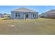 Home backyard featuring blue siding, a pergola, and green grass at 124 Pontoria Dr, Knightsville, SC 29483