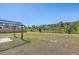 Large backyard with a pergola with lush greenery in the distance at 124 Pontoria Dr, Knightsville, SC 29483