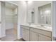 Bathroom with dual sinks, white cabinetry, framed mirrors, and glass enclosed shower at 124 Pontoria Dr, Knightsville, SC 29483