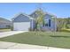 Traditional home with a two-car garage, well-manicured lawn, and tree providing curb appeal at 124 Pontoria Dr, Knightsville, SC 29483