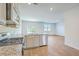 Open kitchen with stainless steel appliances, granite countertops, and view into the spacious living area at 124 Pontoria Dr, Knightsville, SC 29483