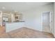 Open-concept living space connecting the kitchen and living area with ample natural light and wood-look floors at 124 Pontoria Dr, Knightsville, SC 29483