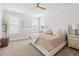 A bright bedroom featuring large windows, a ceiling fan, and neutral decor at 1244 Crooked Oak Rd, Charleston, SC 29492