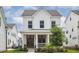 Charming two-story home featuring a welcoming front porch, well-manicured lawn, and classic white siding at 1244 Crooked Oak Rd, Charleston, SC 29492