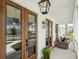 Inviting front porch with comfortable seating, pendant lighting and double doors at 1244 Crooked Oak Rd, Charleston, SC 29492