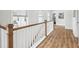Hallway with wood flooring and white trim, with a view to the upper level at 1244 Crooked Oak Rd, Charleston, SC 29492