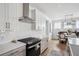 A modern kitchen featuring stainless steel appliances, white cabinets, and a tile backsplash at 1244 Crooked Oak Rd, Charleston, SC 29492