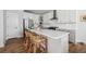 A well-lit kitchen featuring a large island with rattan stools and stainless steel appliances at 1244 Crooked Oak Rd, Charleston, SC 29492