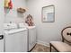 Bright laundry room features modern washer and dryer, shelving, a mirror and stylish decor at 1244 Crooked Oak Rd, Charleston, SC 29492