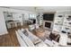 Spacious living room open to the kitchen with a fireplace, built-in shelves, and stylish decor at 1244 Crooked Oak Rd, Charleston, SC 29492