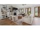 Inviting living room featuring a fireplace, built-in shelving, and double doors to the porch at 1244 Crooked Oak Rd, Charleston, SC 29492