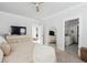 A bright bedroom features neutral decor, a ceiling fan, and an ensuite bathroom in view at 1244 Crooked Oak Rd, Charleston, SC 29492