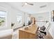 Bright office with large wood desk and a view of the neighborhood from the windows at 1244 Crooked Oak Rd, Charleston, SC 29492
