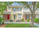 View of townhome exteriors and green lawns with a sidewalk at 125 Macy Cir, Goose Creek, SC 29445