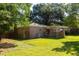 A brick house features a wooden deck, an AC unit, and a green grassy backyard at 1261 Hampshire Rd, Charleston, SC 29412
