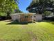 A brick house with a new wooden deck and a well-maintained grassy backyard at 1261 Hampshire Rd, Charleston, SC 29412