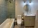 Modern bathroom features a bathtub, tiled shower, gray vanity and marble floors at 1261 Hampshire Rd, Charleston, SC 29412