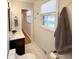 Well-lit bathroom featuring stylish vanity, fixtures, tile floor, and window at 1261 Hampshire Rd, Charleston, SC 29412