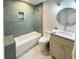 Modern bathroom features a bathtub, tiled shower, gray vanity and marble floors at 1261 Hampshire Rd, Charleston, SC 29412