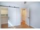 Bedroom closet features a barn door with black hardware and custom storage shelving at 1261 Hampshire Rd, Charleston, SC 29412