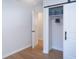 Bedroom closet features a barn door with black hardware and custom storage shelving at 1261 Hampshire Rd, Charleston, SC 29412