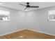 Bright bedroom featuring hardwood floors, white trim, modern ceiling fan, and lots of natural light at 1261 Hampshire Rd, Charleston, SC 29412