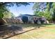 Well-kept brick home with a neat lawn, an American flag, and a wooden privacy fence at 1261 Hampshire Rd, Charleston, SC 29412