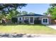 Charming brick home with well-maintained lawn, mature trees, and an American flag at 1261 Hampshire Rd, Charleston, SC 29412