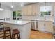 Updated kitchen with white cabinets, quartz countertops, stainless steel appliances, and hardwood floors at 1261 Hampshire Rd, Charleston, SC 29412