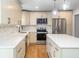 Modern kitchen with white cabinets, quartz countertops, stainless steel appliances, and pendant lighting at 1261 Hampshire Rd, Charleston, SC 29412