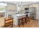 Spacious kitchen featuring a center island with seating, stainless appliances, and light wood floors at 1261 Hampshire Rd, Charleston, SC 29412