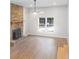 Spacious living room featuring a cozy fireplace, modern flooring, and large bright windows at 1261 Hampshire Rd, Charleston, SC 29412