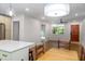 Open-concept living area featuring hardwood floors and a dining area connected to a modern kitchen at 1261 Hampshire Rd, Charleston, SC 29412